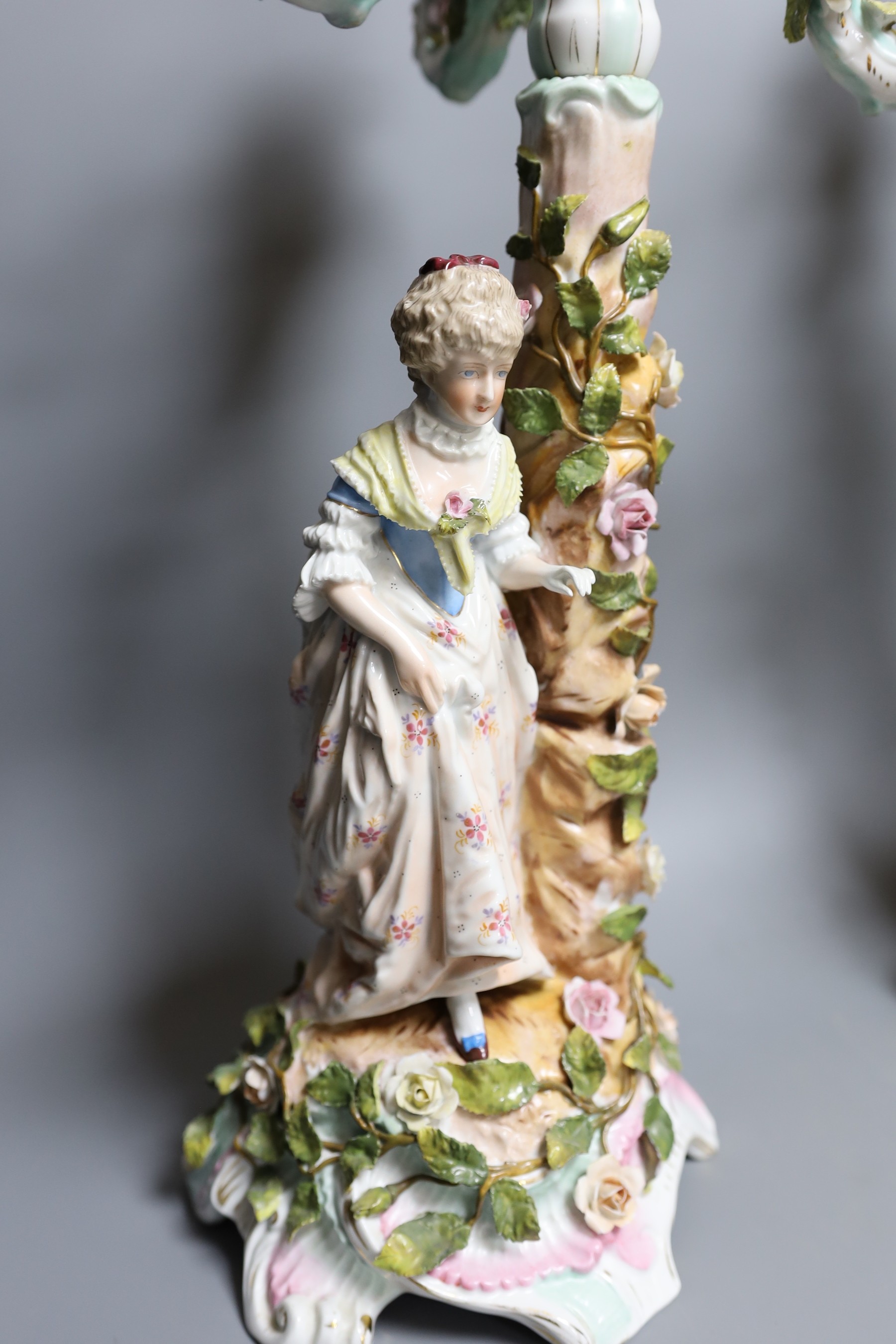 Two German floral encrusted candelabra, tallest 55cm